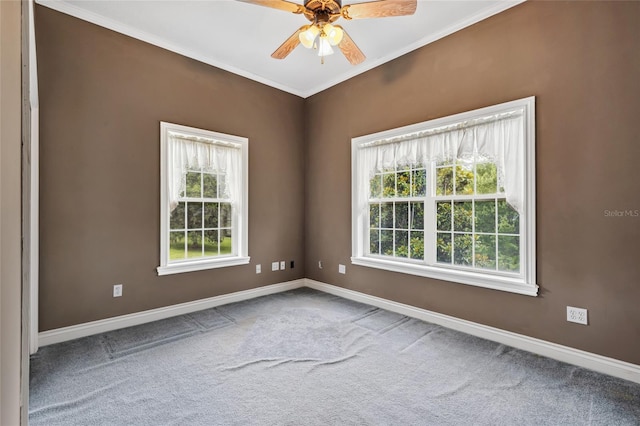 carpeted spare room with crown molding and ceiling fan