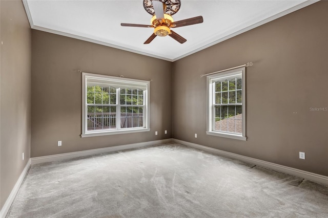 carpeted empty room with ornamental molding and ceiling fan