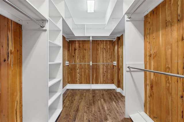 walk in closet with wood-type flooring