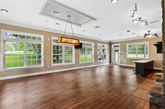 unfurnished living room featuring ornamental molding and dark hardwood / wood-style flooring