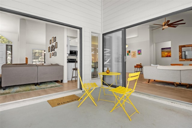 living room with high vaulted ceiling and ceiling fan