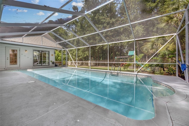 view of swimming pool with a lanai and a patio