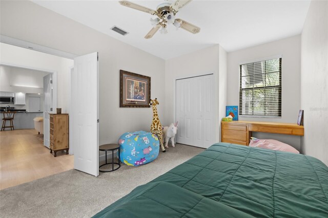 bedroom with carpet flooring, ceiling fan, and a closet