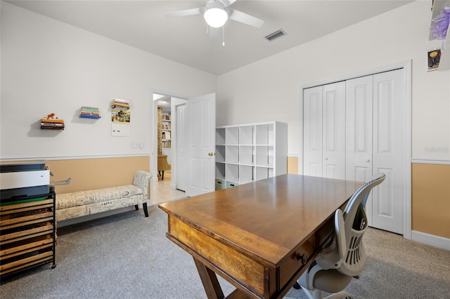 carpeted office with ceiling fan