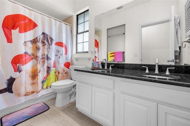 bathroom featuring hardwood / wood-style flooring, vanity, and toilet