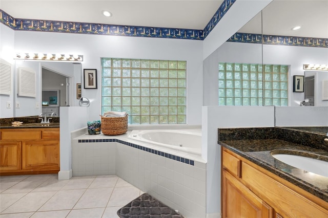 bathroom with vanity, tiled bath, and tile patterned floors