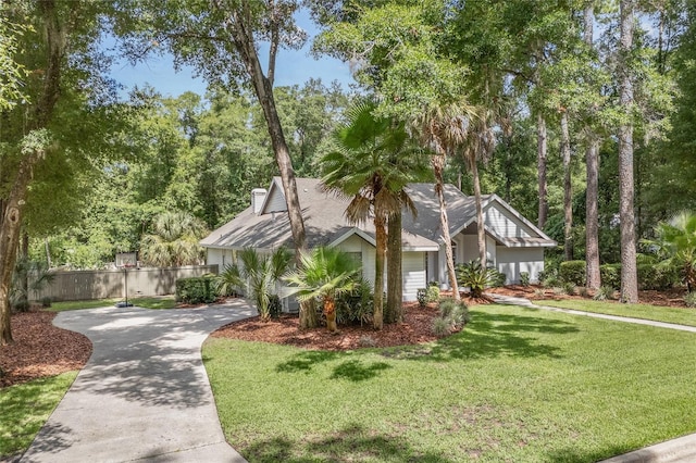 view of front of property featuring a garage and a front lawn