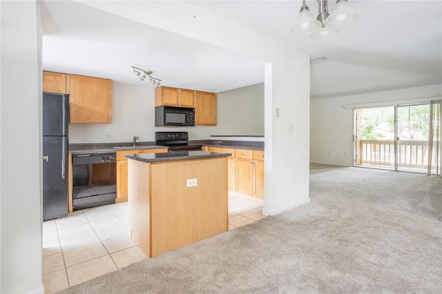 kitchen with a notable chandelier, black appliances, rail lighting, light carpet, and a kitchen island