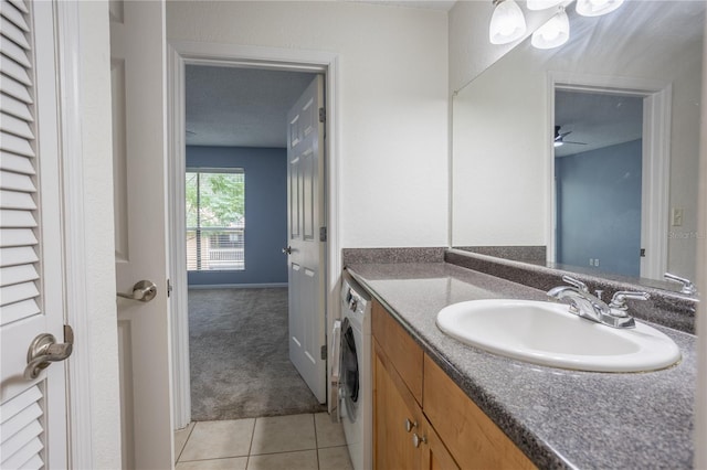 bathroom featuring tile patterned floors, vanity, and washer / dryer