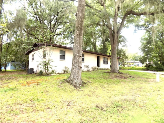 exterior space with a yard and central air condition unit