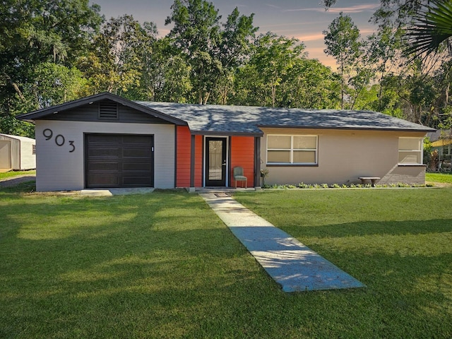 ranch-style home featuring a lawn