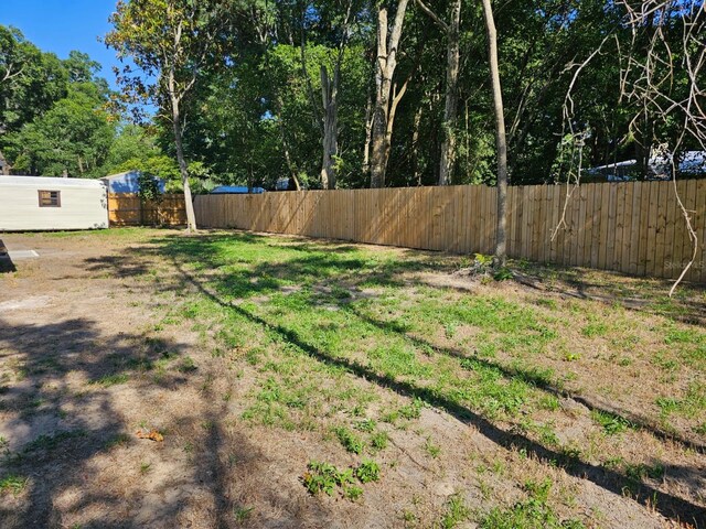 view of yard with an outbuilding and a fenced backyard