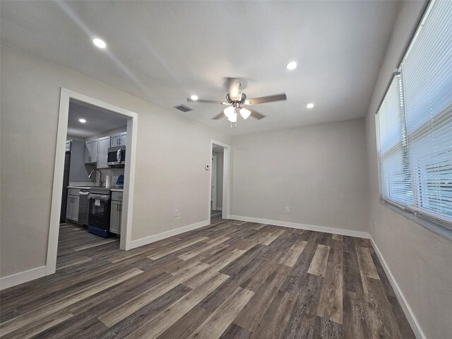 empty room featuring ceiling fan and dark hardwood / wood-style floors