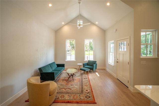 sitting room featuring ceiling fan, high vaulted ceiling, and light hardwood / wood-style flooring