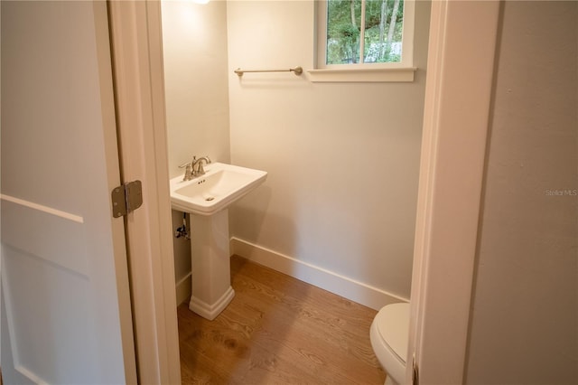 bathroom featuring hardwood / wood-style flooring and toilet