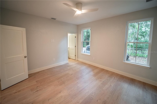 empty room featuring ceiling fan and light wood-type flooring