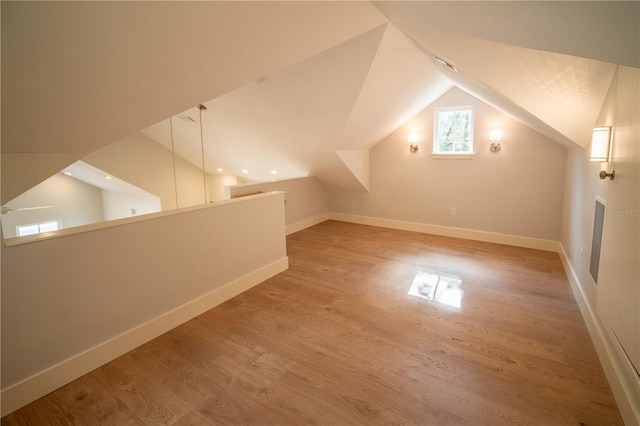 bonus room with wood-type flooring and lofted ceiling