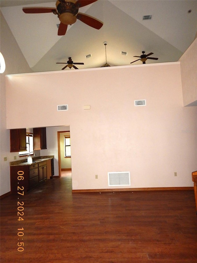 empty room featuring sink, dark hardwood / wood-style floors, and lofted ceiling