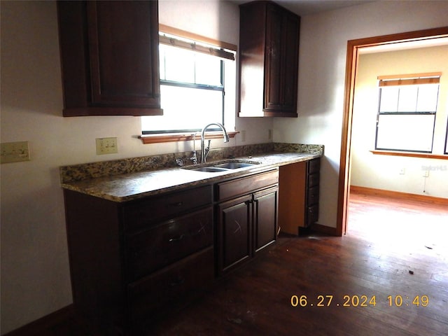 kitchen featuring dark hardwood / wood-style floors, dark brown cabinets, and sink