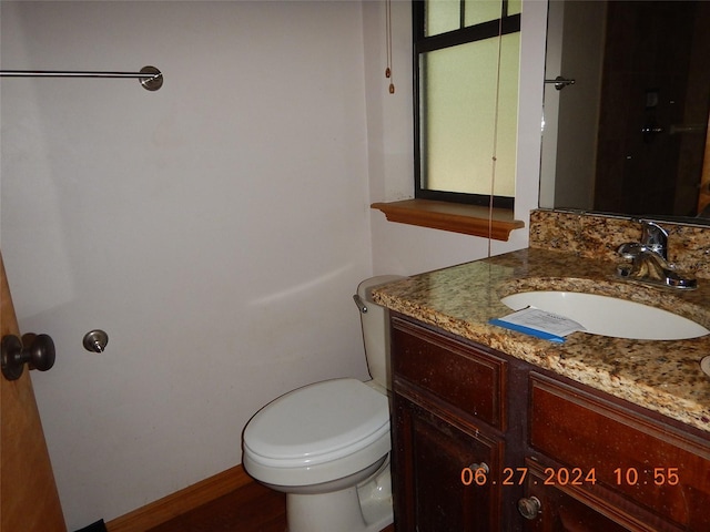 bathroom featuring vanity and toilet