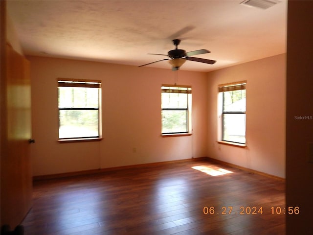 spare room featuring dark hardwood / wood-style floors and ceiling fan