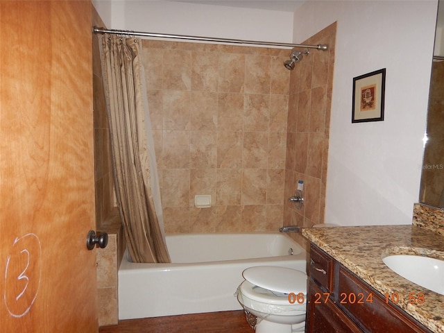 full bathroom featuring shower / tub combo with curtain, vanity, and toilet