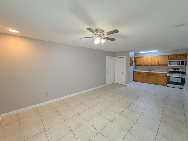 kitchen featuring light tile patterned floors, sink, ceiling fan, backsplash, and stainless steel appliances