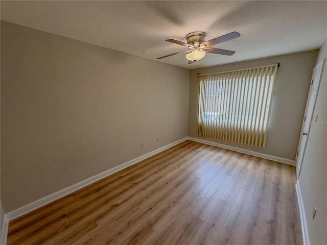 empty room with ceiling fan and light wood-type flooring