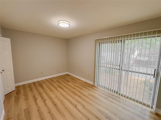 unfurnished room with light hardwood / wood-style flooring and a textured ceiling