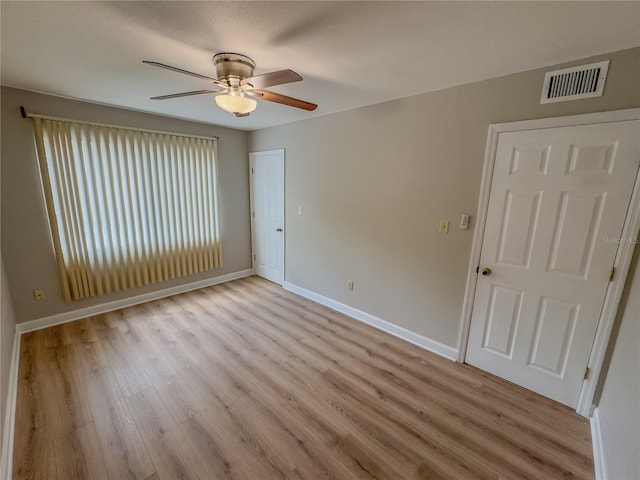 empty room featuring ceiling fan and light wood-type flooring