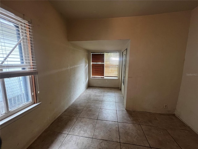 corridor with light tile patterned floors