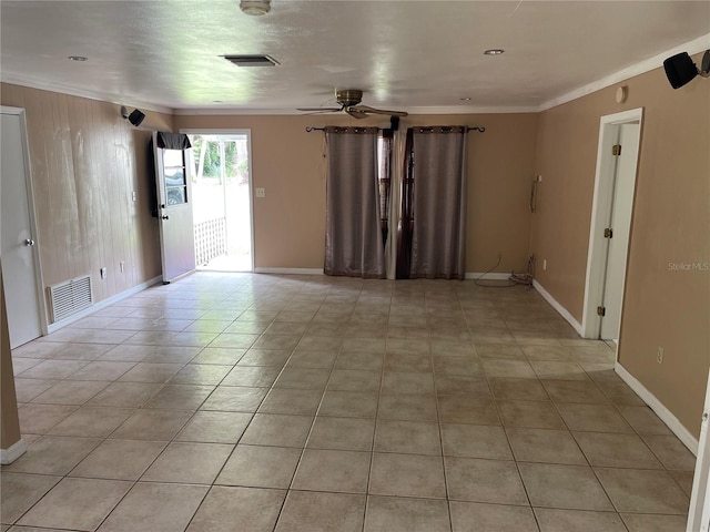 unfurnished room featuring tile patterned flooring, crown molding, and ceiling fan