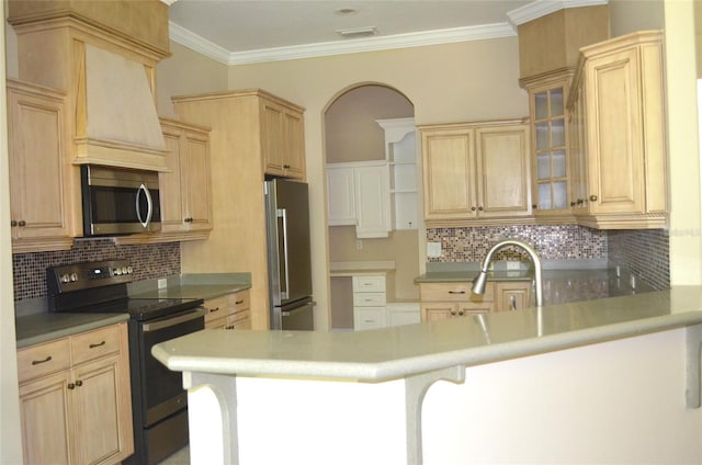 kitchen with light brown cabinetry, appliances with stainless steel finishes, premium range hood, and tasteful backsplash