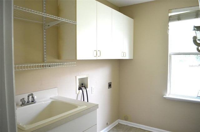 washroom featuring hookup for a washing machine, cabinets, hookup for an electric dryer, and sink