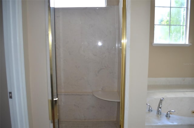 bathroom featuring plus walk in shower