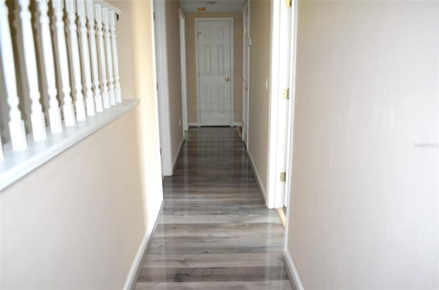 corridor with hardwood / wood-style floors