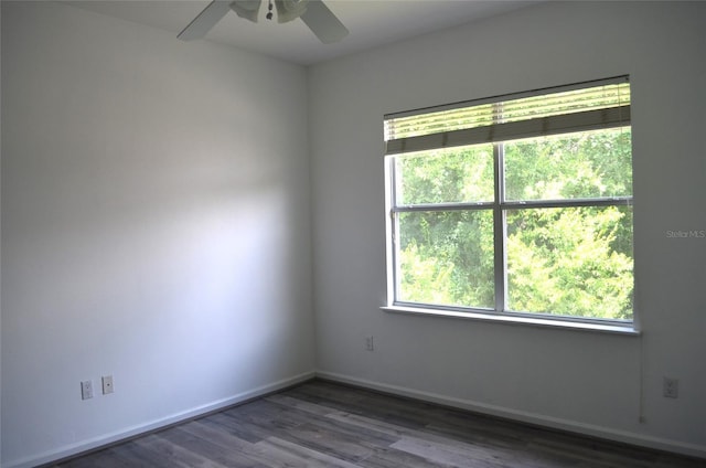 empty room featuring dark wood-type flooring and ceiling fan