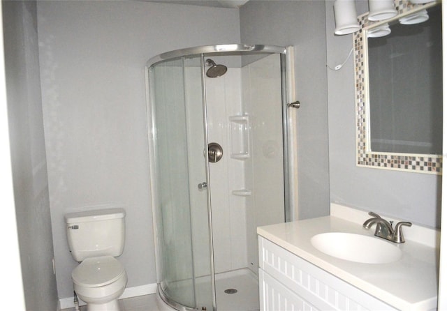 bathroom with vanity, an enclosed shower, tile patterned flooring, and toilet