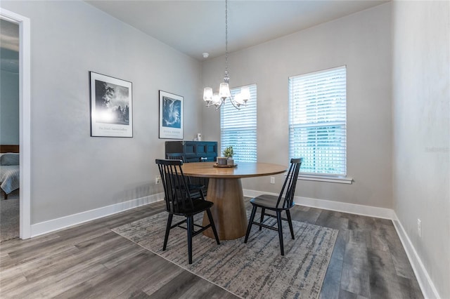 dining space with a notable chandelier, plenty of natural light, and dark hardwood / wood-style floors