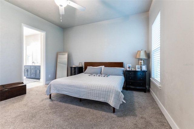 bedroom featuring carpet flooring, multiple windows, ensuite bathroom, and ceiling fan