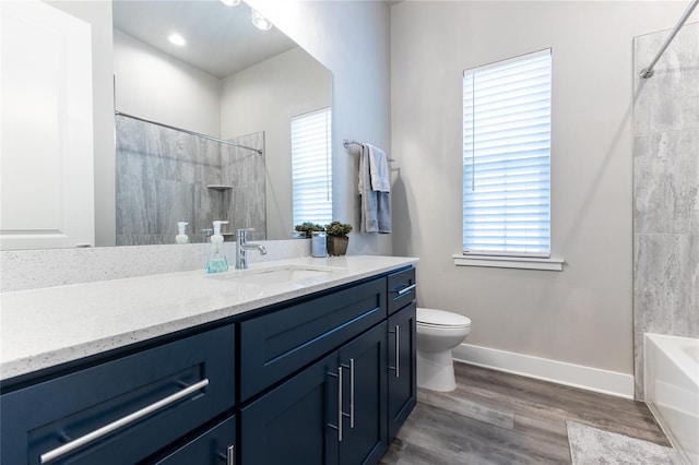 full bathroom with vanity, hardwood / wood-style flooring, toilet, and shower / washtub combination