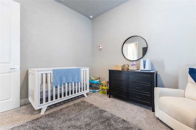 bedroom featuring vaulted ceiling, carpet floors, and a nursery area