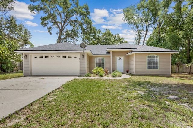 ranch-style house with a garage and a front yard