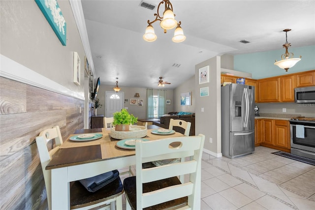 dining space featuring lofted ceiling, light tile patterned floors, and ceiling fan