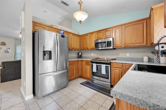 kitchen with stainless steel appliances, light tile patterned flooring, vaulted ceiling, and decorative light fixtures