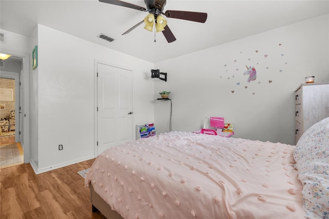 bedroom with ceiling fan and light hardwood / wood-style floors