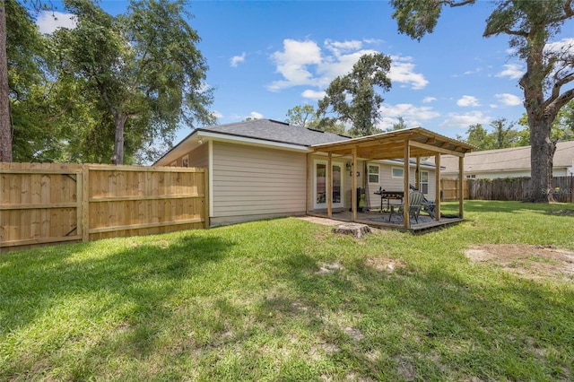 back of property featuring a lawn and a patio