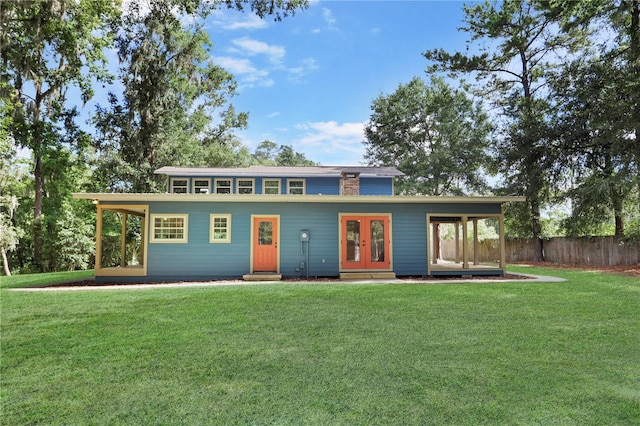 view of front of property with french doors and a front lawn