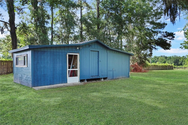 view of outbuilding featuring a lawn