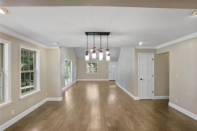 interior space featuring hardwood / wood-style flooring, vaulted ceiling, and ornamental molding